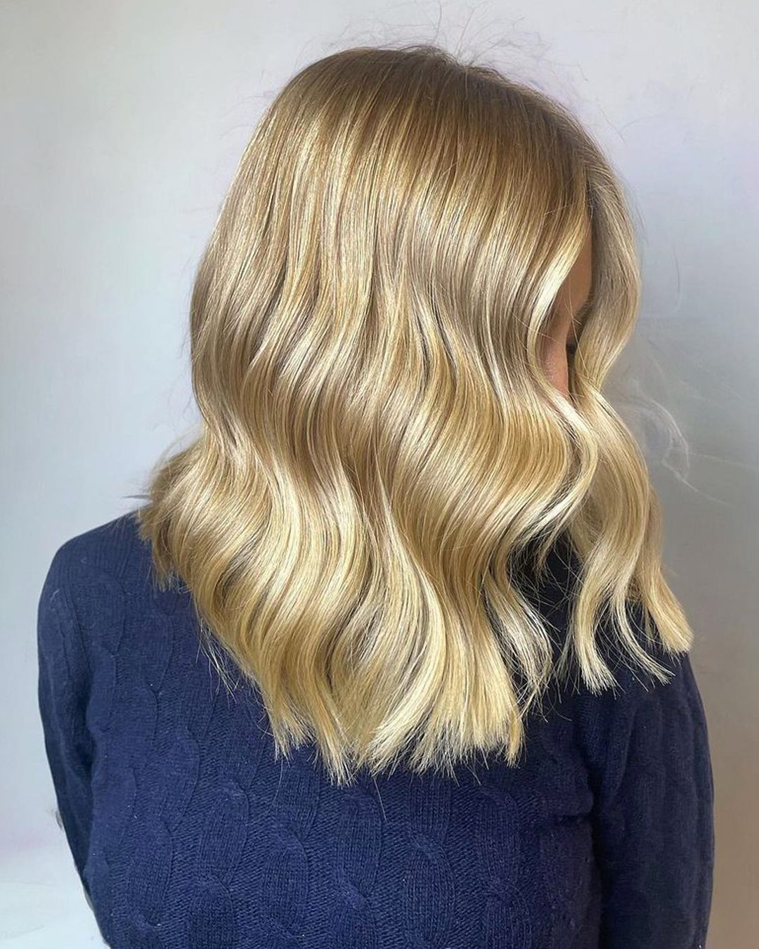 Soft blonde balayage with a lived-in wave, by Urban Salon Manchester