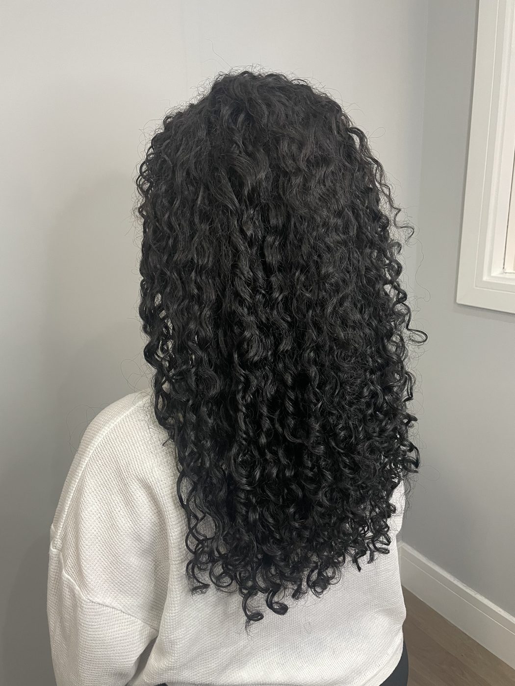 Long, defined curls after a curly cut at Urban Salon Manchester